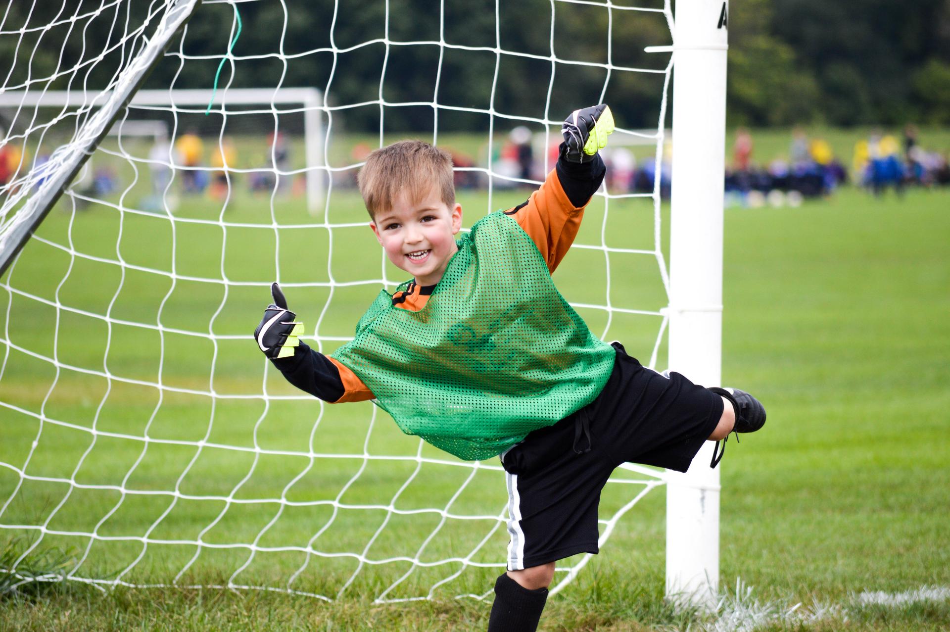 Boy playing youth soccer outdoors