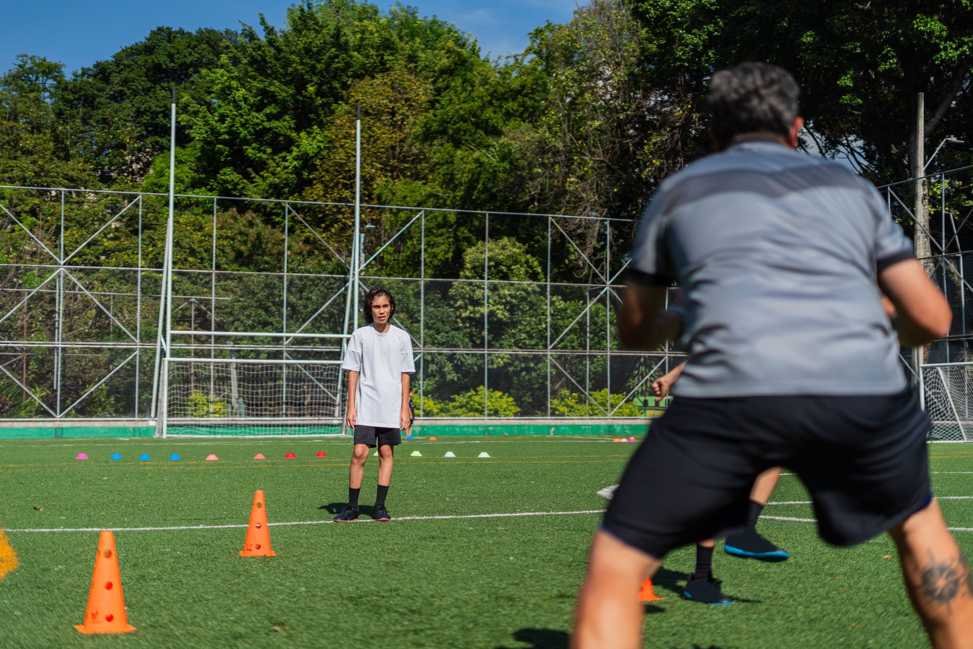 soccer teacher trains children from his sports school