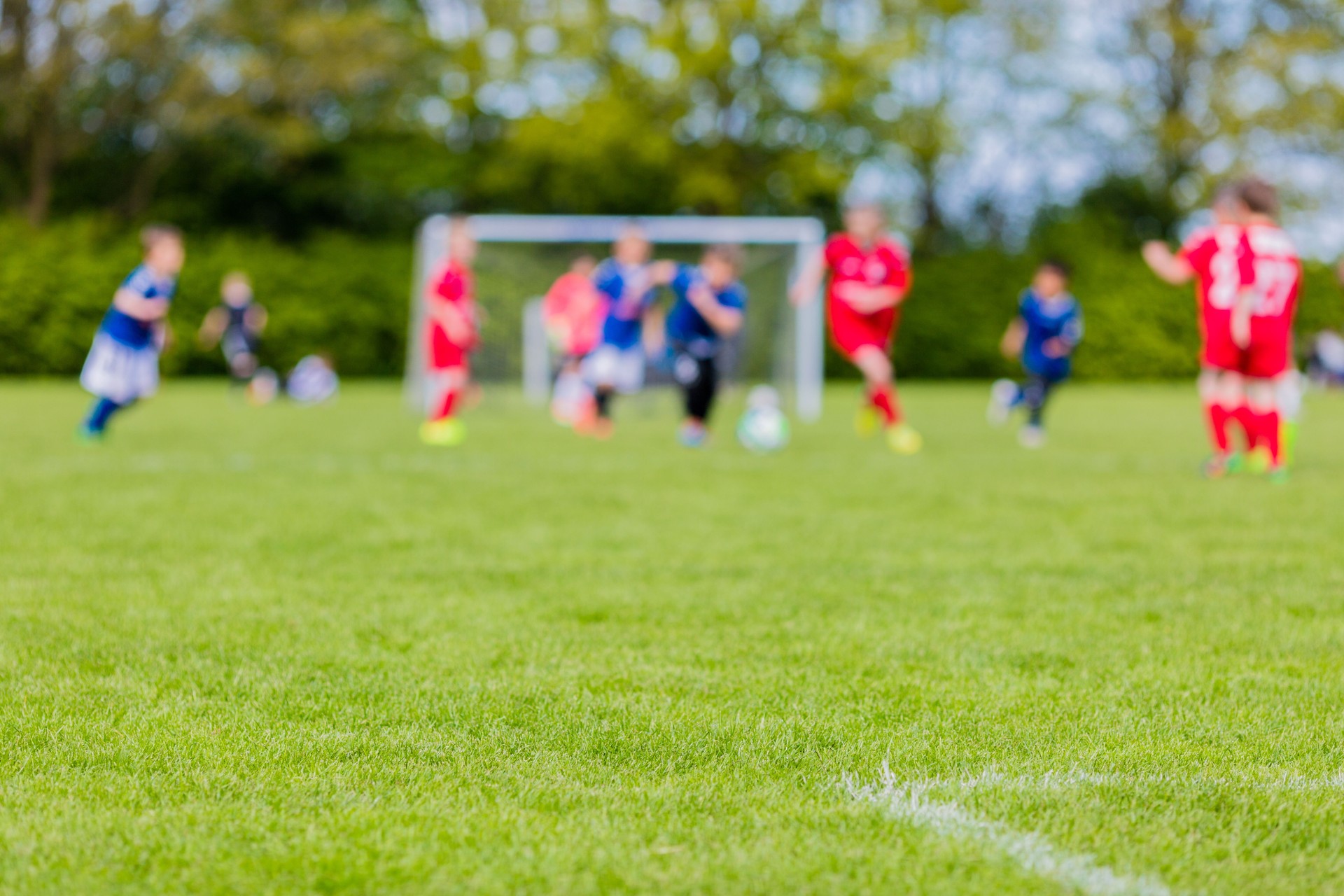 Blurred kids playing youth football match